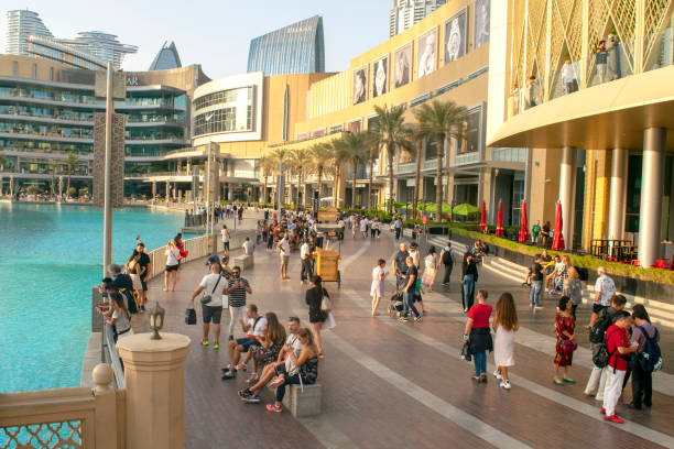 Dubai / UAE - November 5, 2019: World's largest shopping center. Dubai shopping mall exterior with tourists.